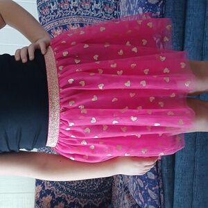 Girls size 7/8, bright pink tule skirt adorned with golden hearts.